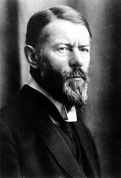 A century-old photograph shows the sociologist Max Weber, who has a distinctively pointy beard and looks concerned.