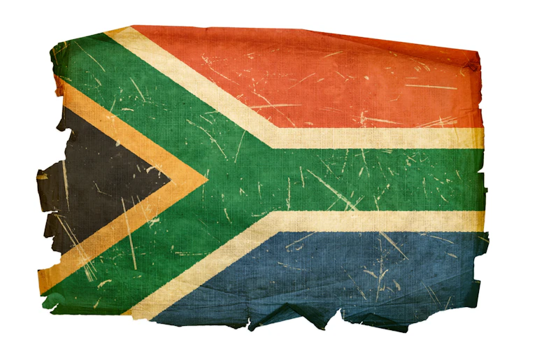 Tattered flag in red, white, green, blue, black and yellow