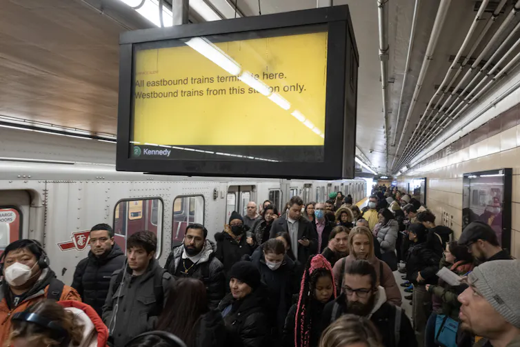 A crowd of people on a subway platform