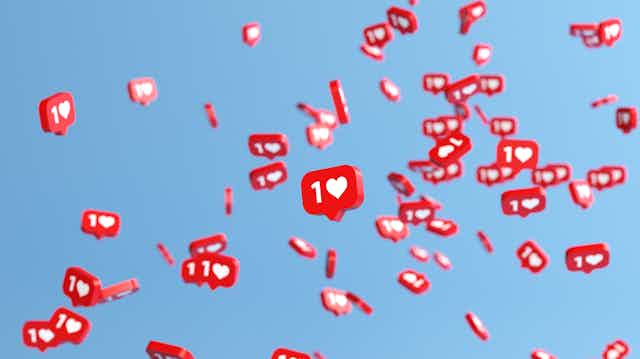 dozens of red rectangles with a numeral one and heart symbol appear to float in the air