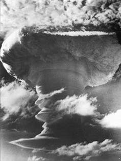 The tall mushroom cloud of a British hydrogen bomb that was detonated over Kiritimati in 1957.