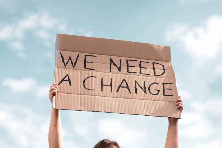 person holding climate protest sign.