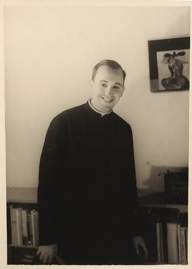 A young man smiles.
