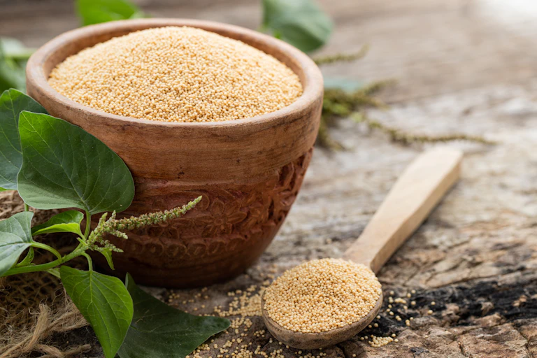 A wooden bowl filled with brown grains