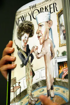 A hand holding the New Yorker magazine showing a drawing of Michelle and Barak Obama.