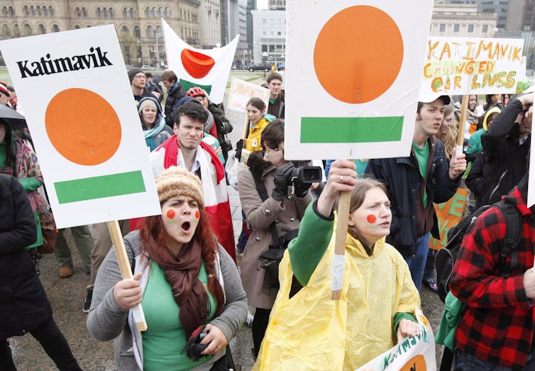 Jóvenes que sostienen placas que dicen 'Katimavik'.