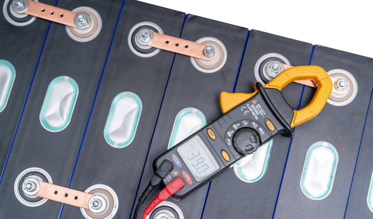 EV battery with meter measuring voltage.