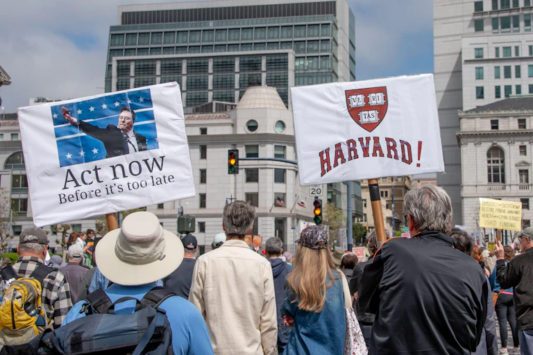 A protest march, with signs in San Francisco city centre.