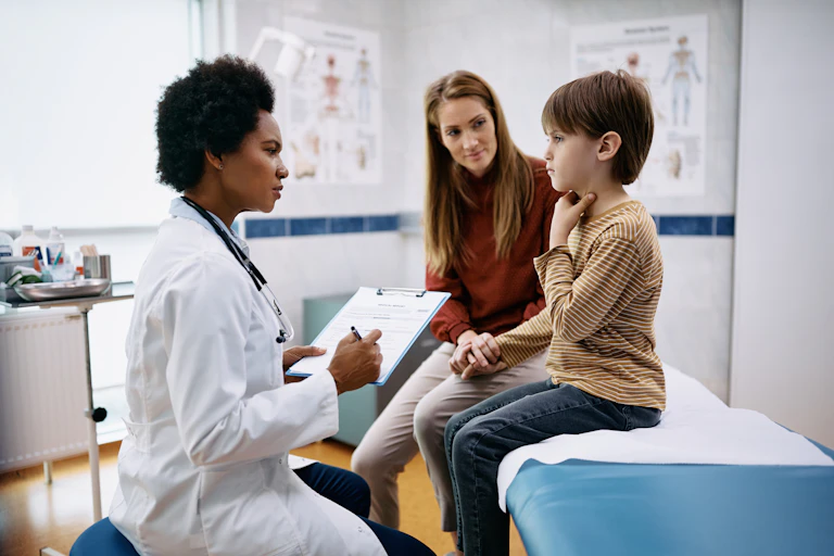 A doctor with a mother and boy in an examination room