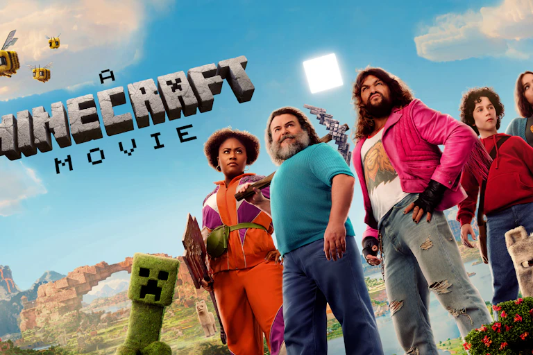 A group of five people standing together with the words A minecraft movie written above them.