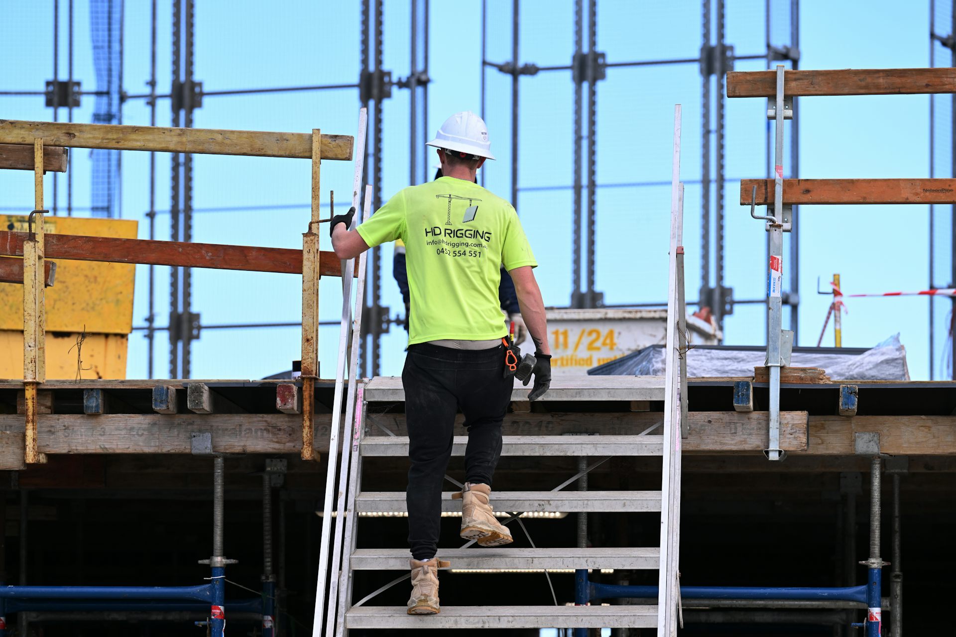 A worker at construction works on a building site for apartments