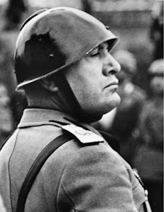 This is a Nov. 11, 1937 file photo of Italian Premier-dictator Benito Mussolini reviews troops before the national Italian monument in honor of the 68th birthday of King Victor Emmanuel in Rome
