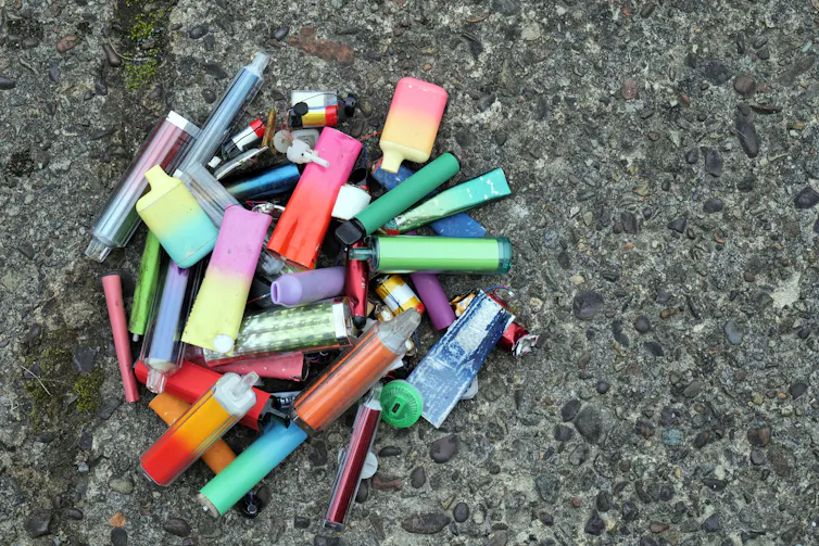 A collection of vapes on the floor.