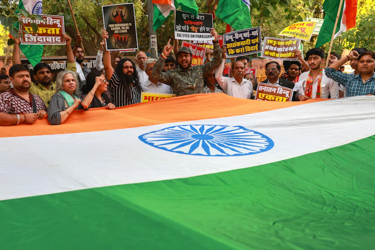 Members of the Save India Foundation protest about the Kashmir terror attack with a large INdian national flag, New Delhi 23 April 2025.