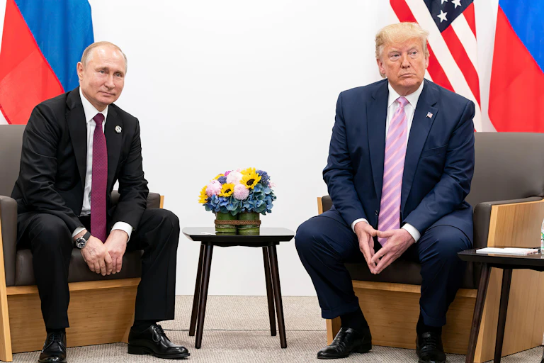 Presidents Trump and Putin sitting next to each other.