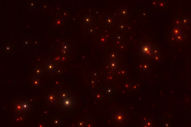 Red shimmering energy particles, depicting the nanoparticles used to create nanotechnologies.