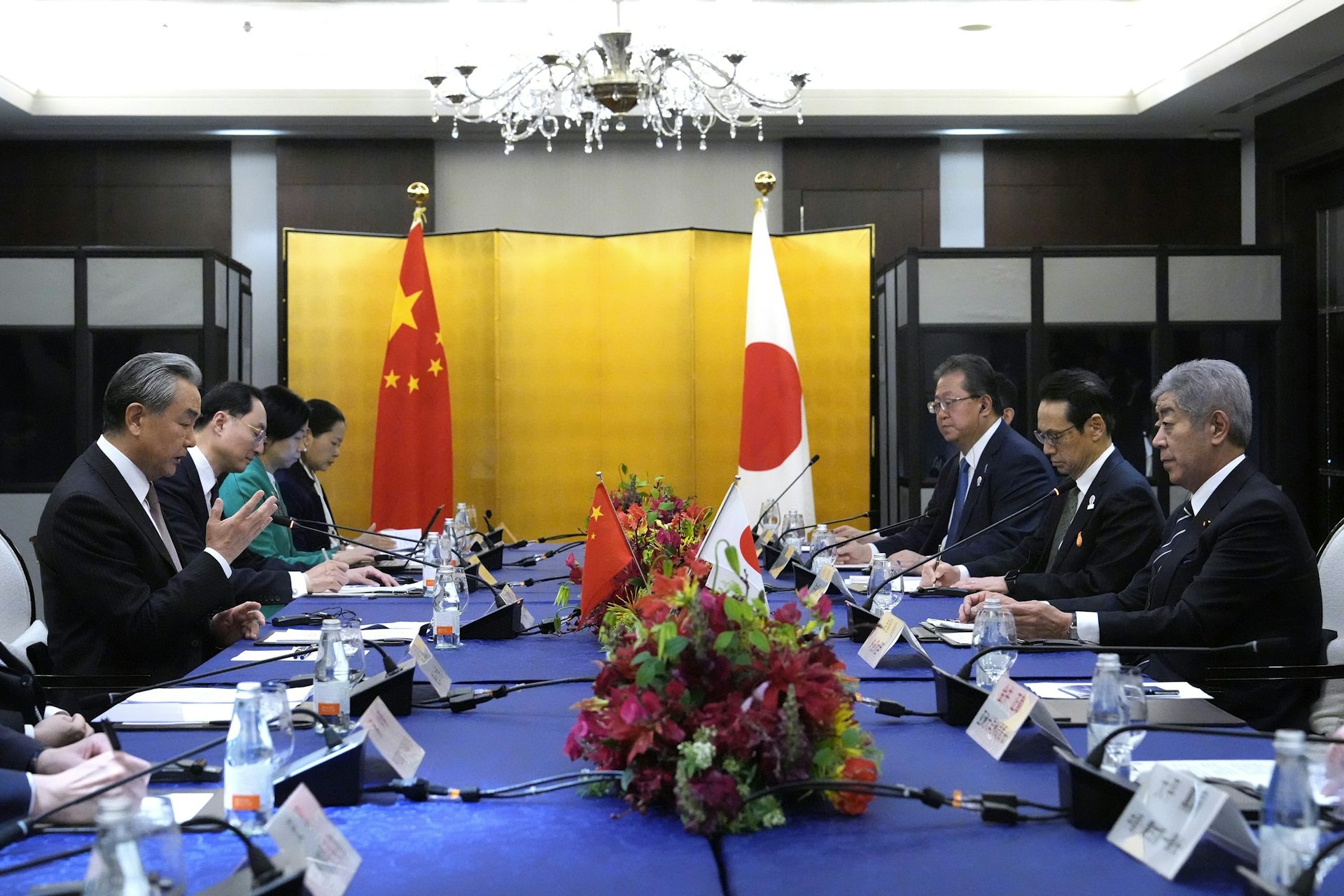 Takeshi Iwaya and Wang Yi sat across a table during a meeting.
