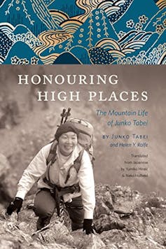 Front cover of Honouring High Places, which features a black and white image of Tabei smiling as she climbs a rocky mountain