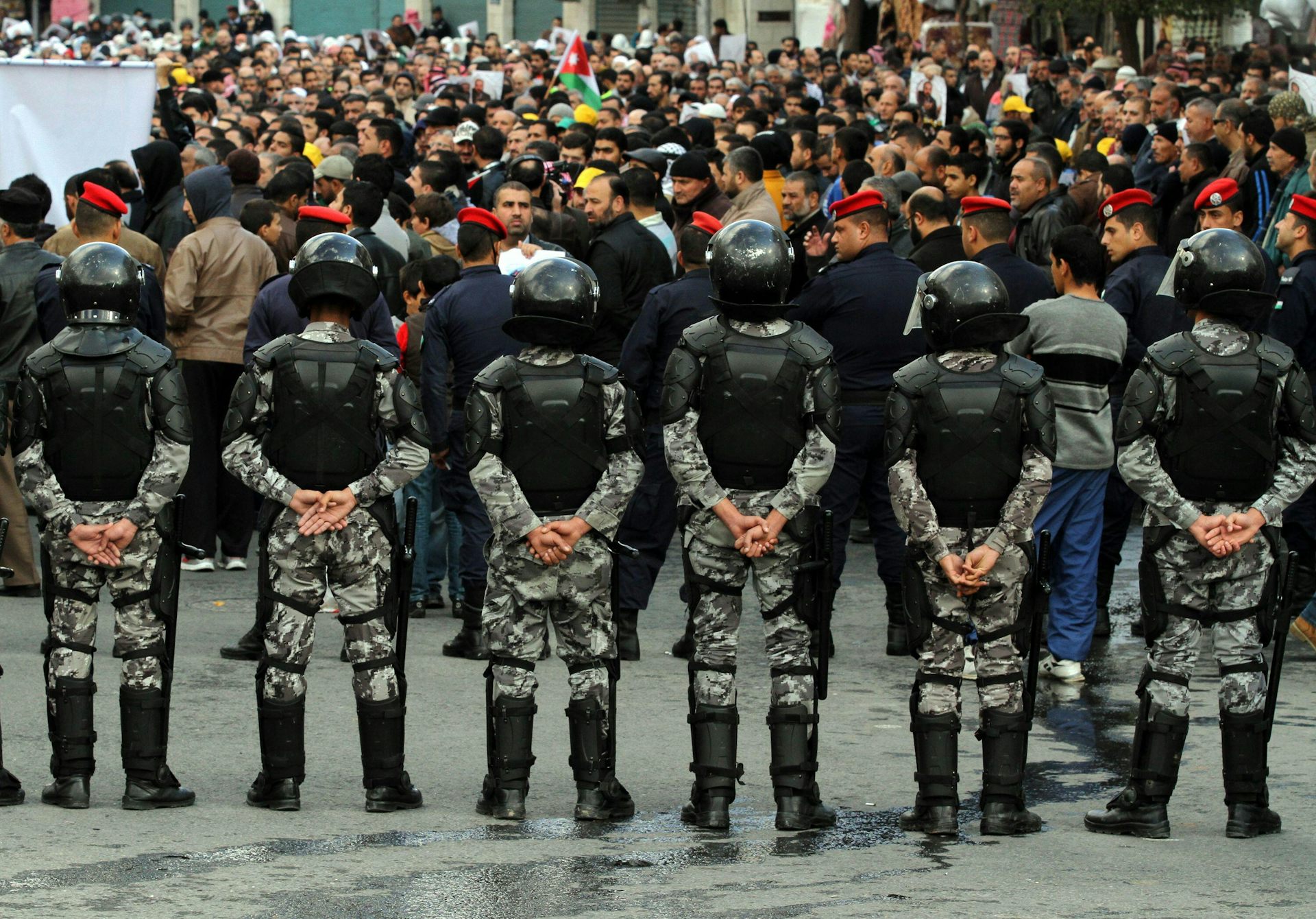 Jordanian security forces surround a demonstration.