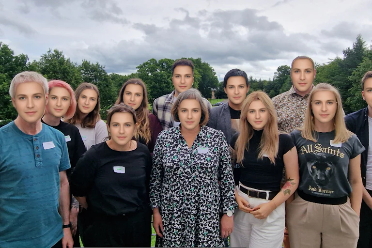 A group of people with a computerised average face.