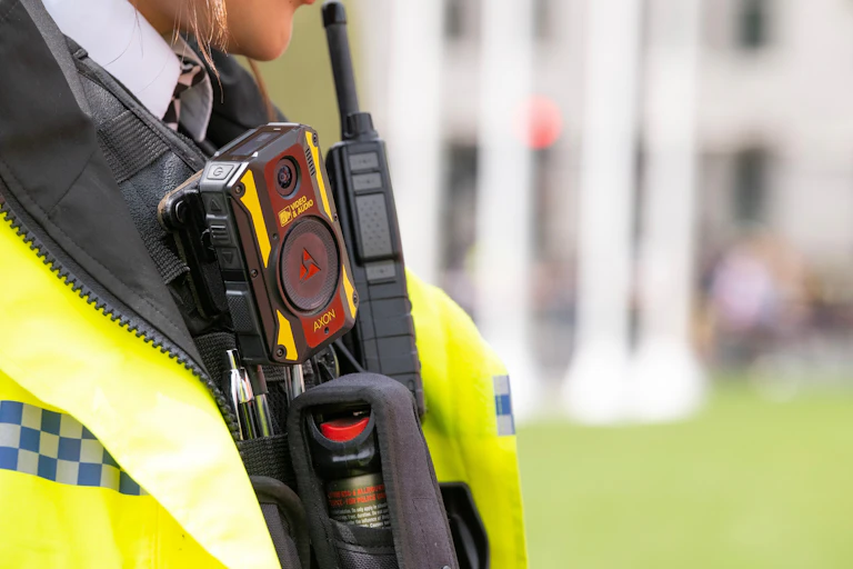 Close up of a body camera on the chest of a female police officer