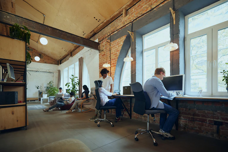 group of people in a co-working space in a renovated old building.