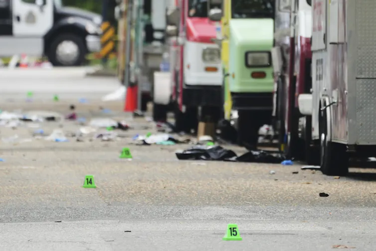 Small green numbered evidence markers line a walkway.
