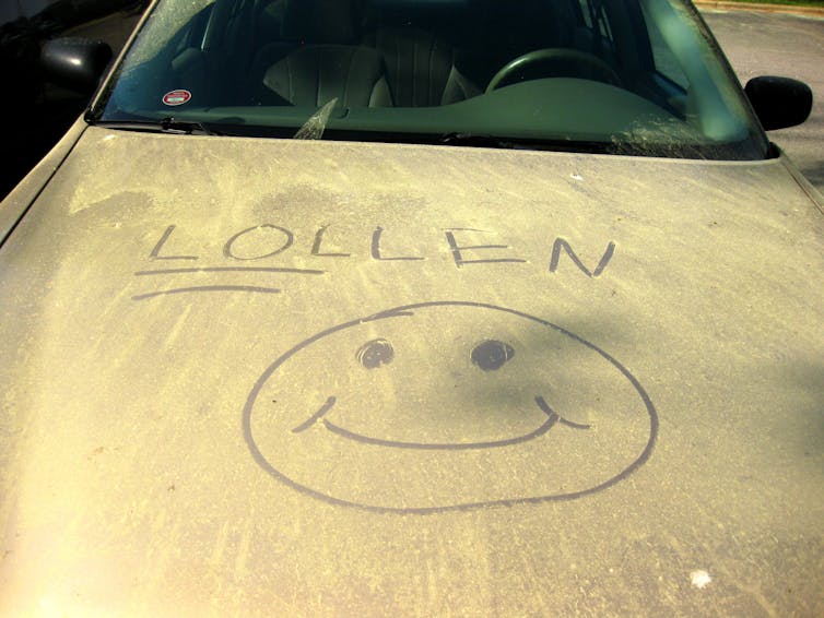 A car covered in yellow. Someone drew a smiley face with the words 'LOLLEN,' with LOL underlined.