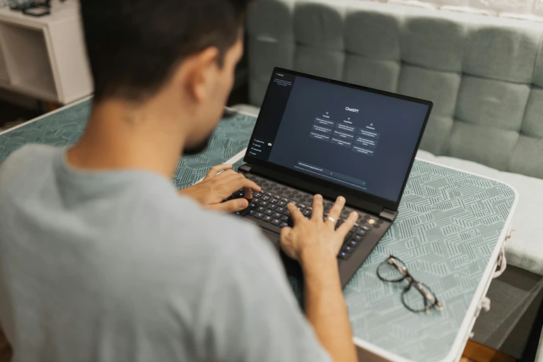 Man using ChatGPT on a laptop
