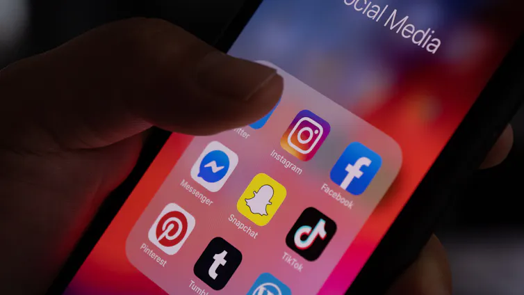 A phone screen displaying icons of multiple social media platforms.