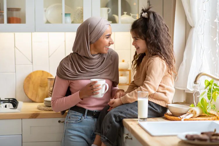 Mother and daughter talking in kitchen