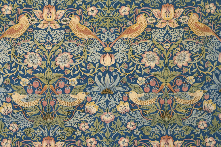 A piece of repeat-patterned material showing thrushes, foliage and strawberries.