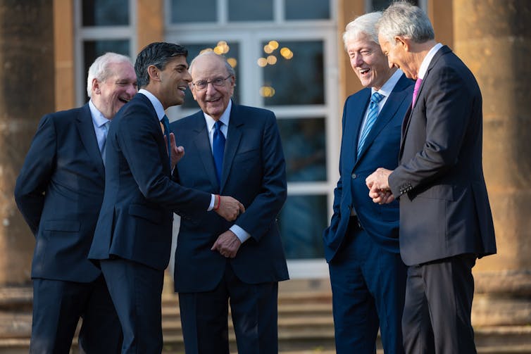 Rishi Sunak with Tony Blair, Bertie Ahern, Bill Clinton and George Mitchell talking and laughing together 25 yuears after the Good Firday agreement was signed.