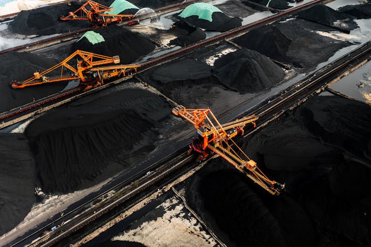 Coal in huge piles with big excavators