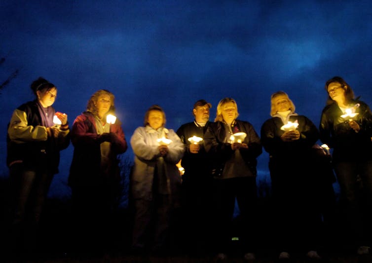 A legislation seeks to give protection to kids from intercourse offenders − two decades later, the jury remains to be out 1 Seven people standing in a row hold candlelights at dusk.