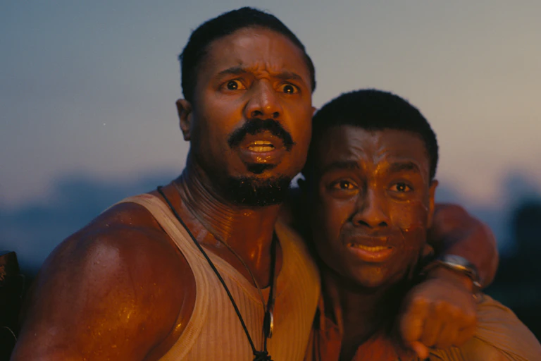 Michael B. Jordan and Miles Caton looking very scared in a still from Sinners