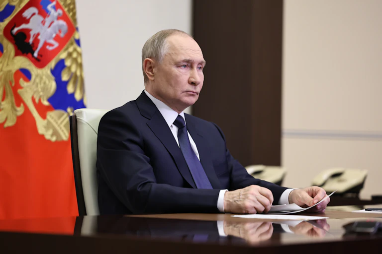 Vladimir Putin sat at a table.