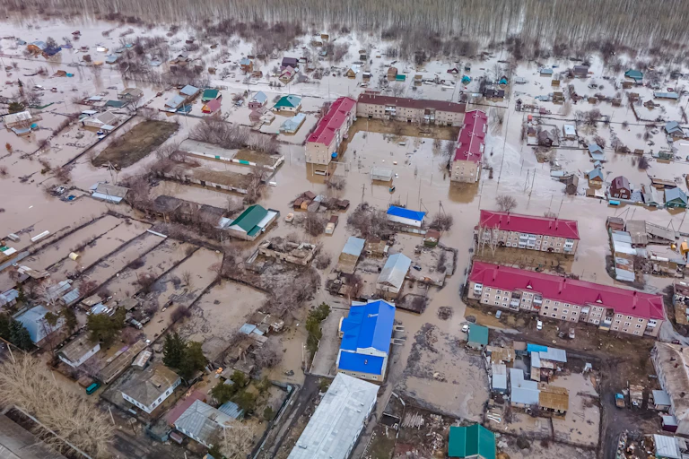 View from overhead of a town flooded with dirty water