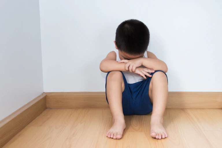 sad boy sat on floor