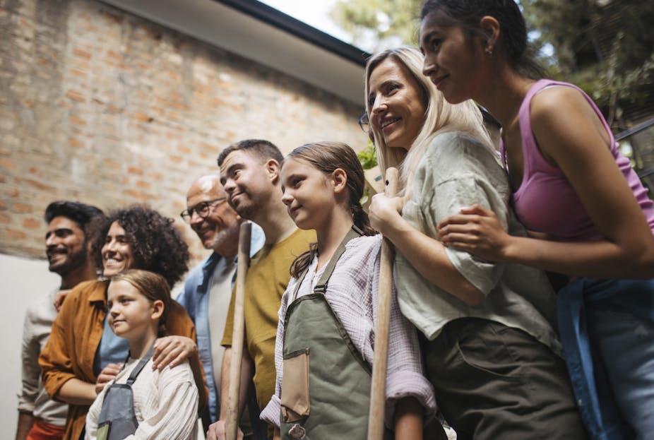 group of people of varying ages lined up looking at something out of frame