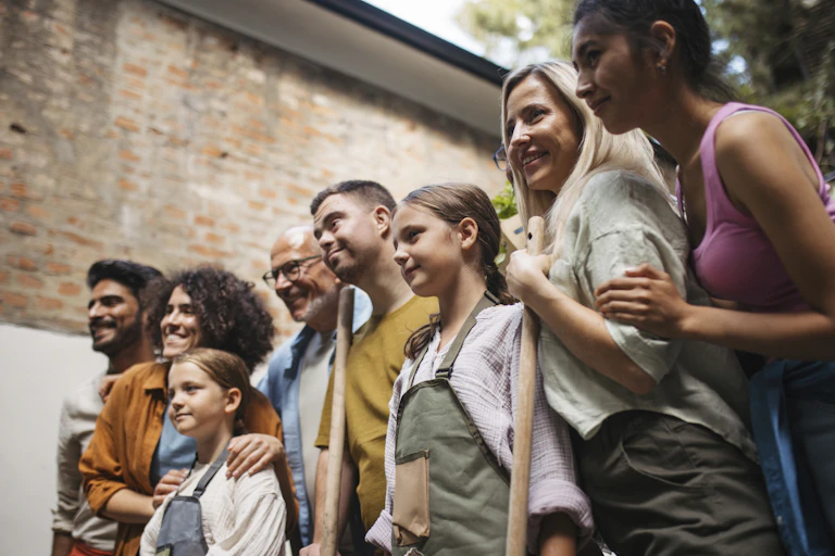 group of people of varying ages lined up looking at something out of frame