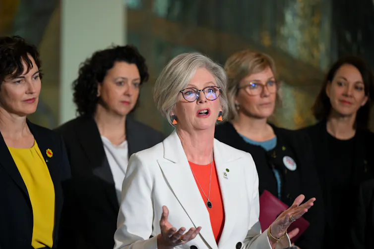 Five female MPs addressing the media