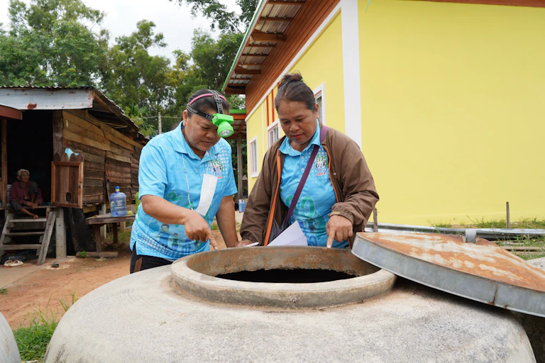 Village health Volunteers in Thailand surveying mosquito breeding sites to prevent dengue