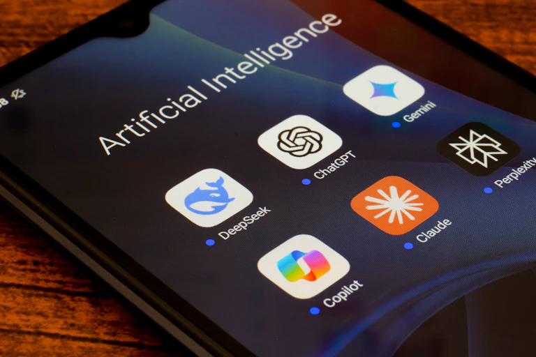 The artificial intelligence apps DeepSeek, ChatGPT, Google Gemini, Copilot, Claude, and Perplexity are seen displayed on a smartphone.
