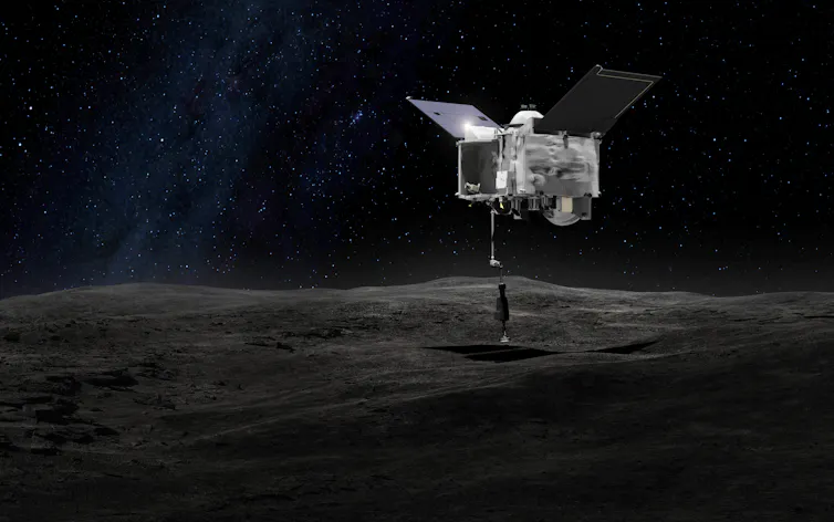 A drawing of a spacecraft, which looks like a metal box with two solar panels, one on each side like wings, and an arm reaching down to the rocky surface of an asteroid.