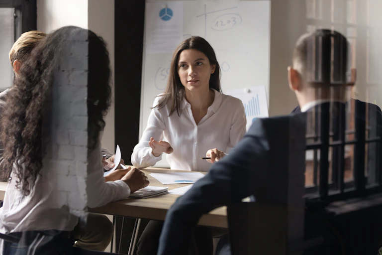 A group of people sitting around a conference table having a discussion