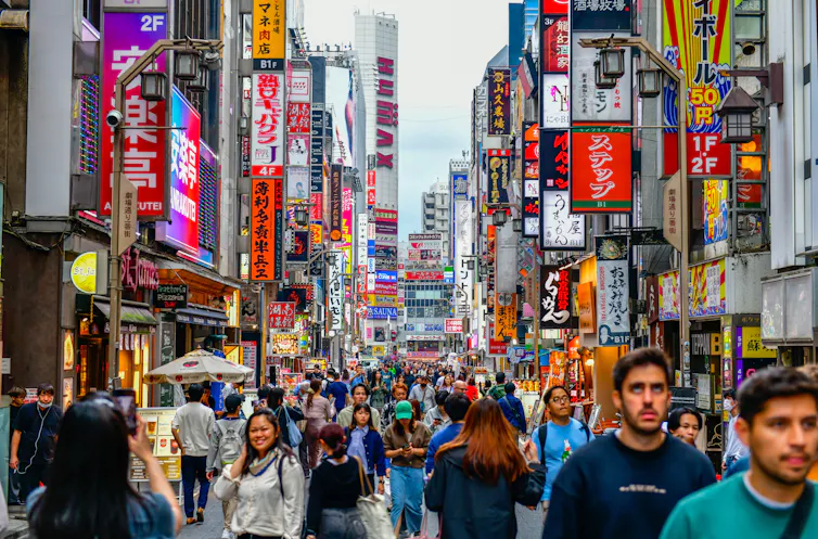 A city street crowded with people.