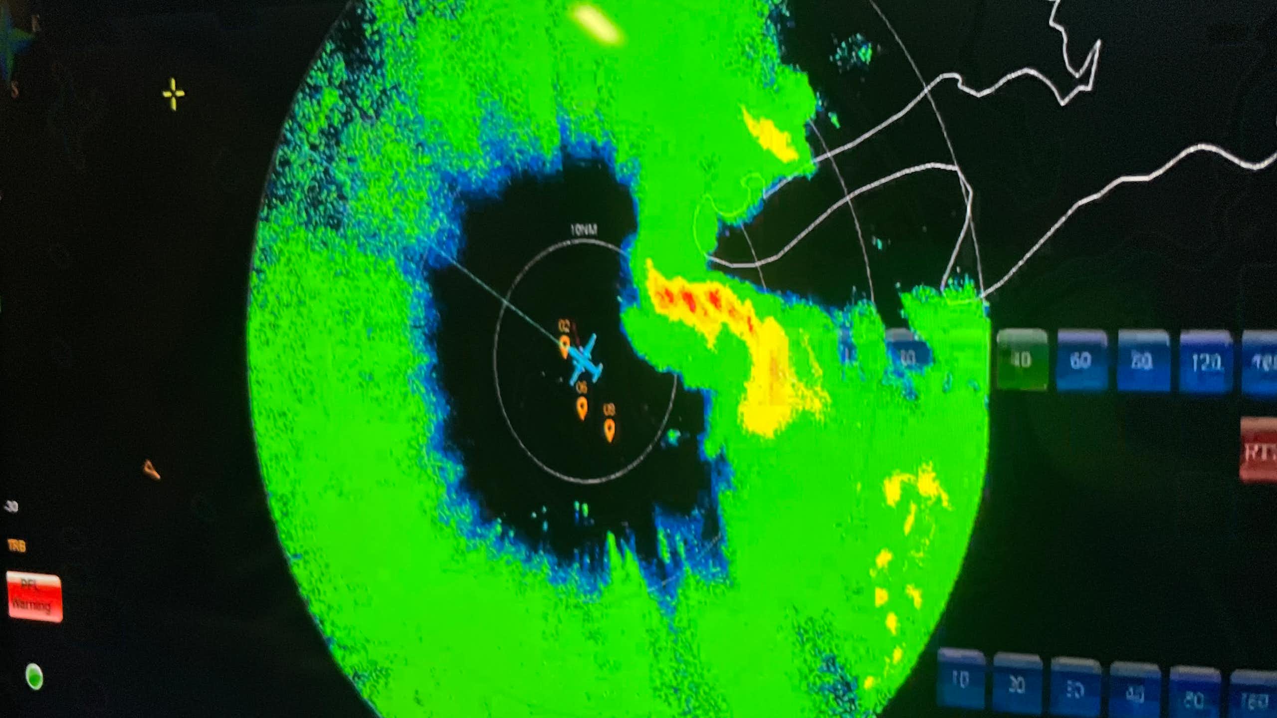 A radar shows a plane in the center of a hurricane