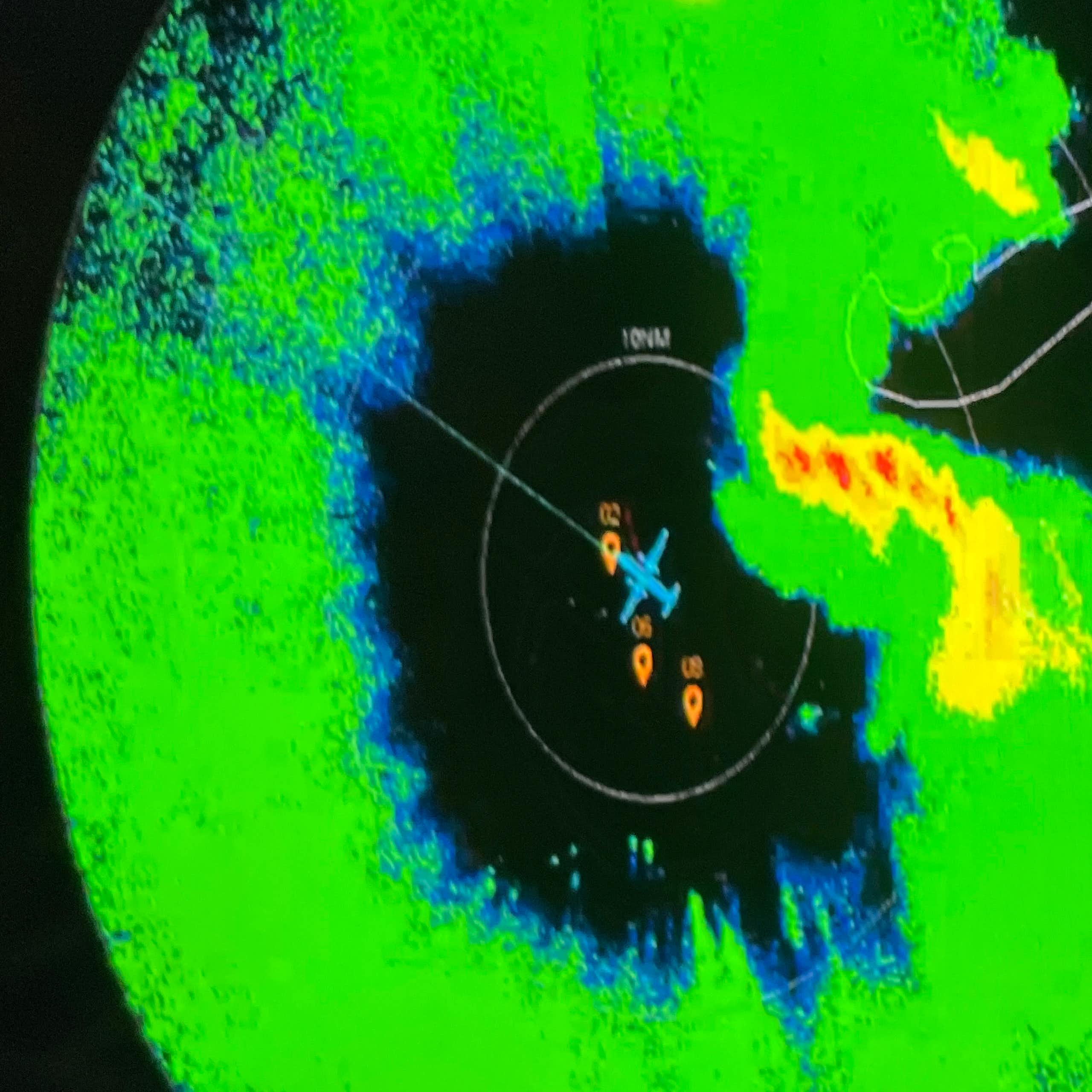 A radar shows a plane in the center of a hurricane
