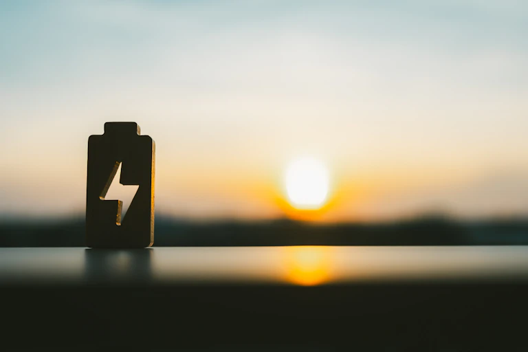 A battery silhouette on a horizon with a setting sun.